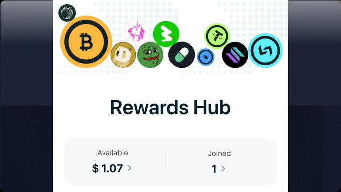The image shows a screenshot of a rewards hub page from a cryptocurrency exchange, where various coins are listed with icons and prices displayed below them. The focus of this particular image seems to be on Bitcoin's icon at the top left corner, indicating that it is featured prominently on the page.