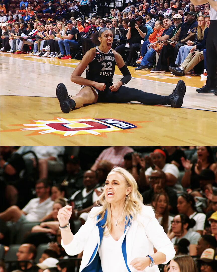 The image shows a woman sitting on the floor with her legs crossed, possibly after a basketball game or practice session. The scene also includes several people standing around her, some of whom are wearing hats. In addition to these individuals, there are multiple chairs scattered throughout the area. A crowd of fans can be seen in the background, indicating that this is likely taking place at a sports event or gathering.