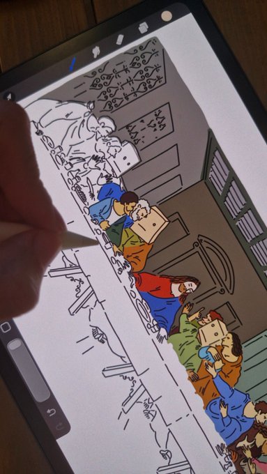 A hand uses an Apple Pencil to digitally illustrate a scene reminiscent of "The Last Supper," showing a long table with various figures in colorful clothing seated against a wooden background on an iPad screen.