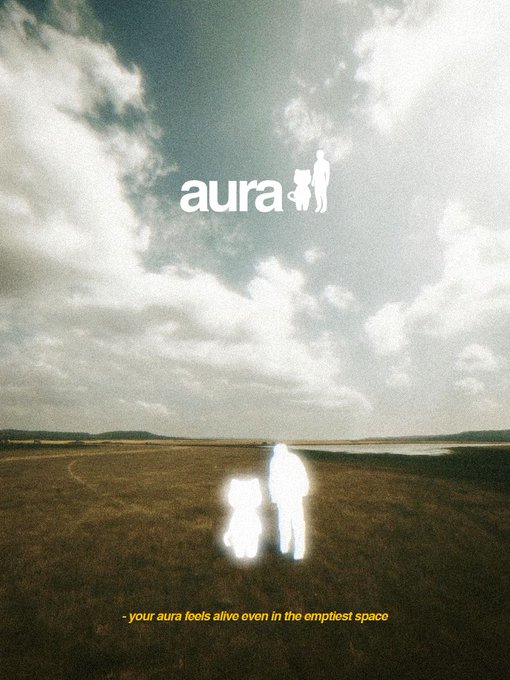 Album-style poster featuring two silhouetted glowing figures in a grassy field under a cloudy sky, with the text 'aura' and the tagline '- your aura feels alive even in the emptiest space'.