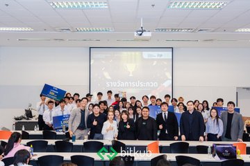 A group photo of attendees at an academic conference or class in a lecture hall, with a screen in the background reading 'kmitl.ac.th' and Thai text.