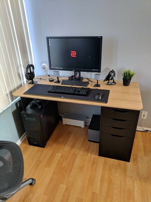 The image shows a computer desk with a desktop computer setup including a monitor, keyboard, mouse, and speakers. The desk also has a plant placed next to it, adding some greenery to the workspace. The photo is related to the post about GM Why let your money sit idle when the @useTria Card lets it earn yield, earn cashback, and stay spendable from one unified balance? as it highlights the importance of utilizing technology like the @useTria Card for managing finances efficiently and maximizing savings.