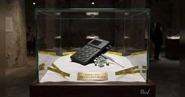 A mobile phone and security bracelet are displayed in a glass case labeled "EXHIBIT 4.0.1 MKS SECURITY BREACH," alongside the accompanying post discussing the ongoing Coldcard security breach saga, where approximately 1,360 BTC have been stolen as of August 3, prompting Coinkite to release an emergency firmware update in response.
