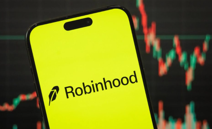 A smartphone displays the Robinhood app logo against a background of a red-and-green candlestick stock chart, visually reinforcing the post's claim of Robinhood Chain shattering its previous revenue benchmarks with a record $6 million in daily fees amid booming onchain trading activity.