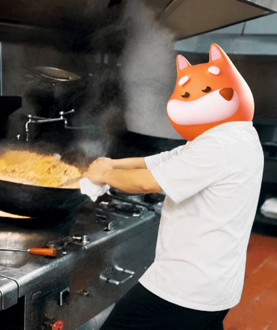 A photograph of a person in a white chef's uniform cooking at a stove with a large wok, but their head has been replaced with the same orange Shiba Inu dog emoji seen in the previous image.