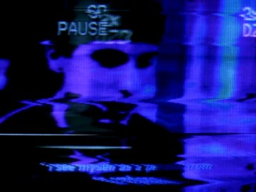 A glitchy, VHS-style image showing a dark figure with the word 'PAUSE' visible, featuring blue chromatic aberration and distortion effects.