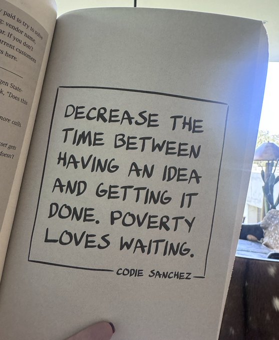 An open book displaying a quote attributed to Codie Sanchez: 'DECREASE THE TIME BETWEEN HAVING AN IDEA AND GETTING IT DONE. POVERTY LOVES WAITING.'