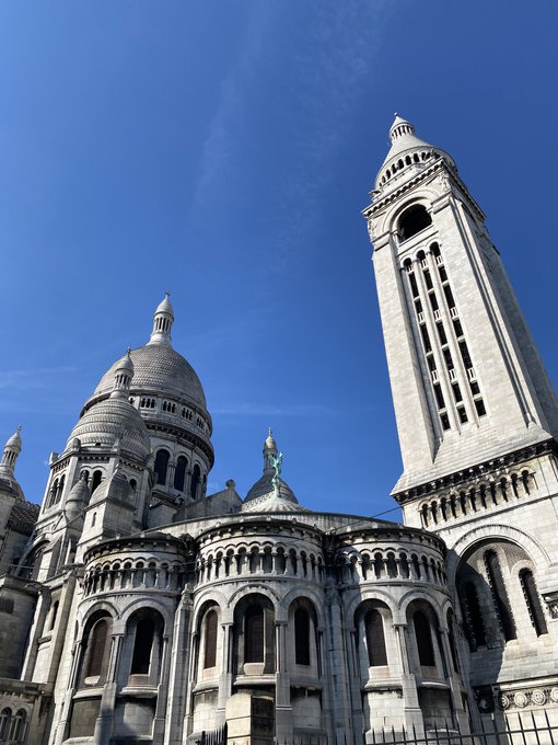 A majestic white stone basilica with a tall bell tower and domed roof rises against a clear blue sky, with a green statue perched on one of its spires.

The image's grand, towering architecture contrasts with the chaotic "killed two agents" post, while the peaceful, quiet scene above mirrors the "stack finally runs quiet" sentiment of calm after a rough day.