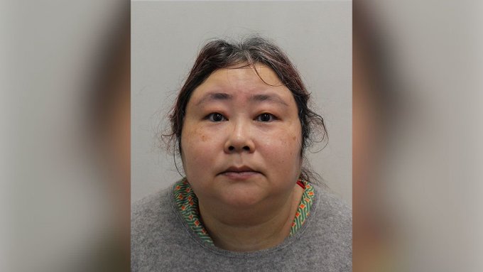 A woman with dark hair pulled back, wearing a gray sweater with a colorful patterned neckline, is shown in what appears to be a mugshot-style photograph against a plain wall. The image relates to the accompanying post as it likely depicts Zhimin Qian, the "Crypto Queen" who was involved in a fraudulent scheme involving 70,000 Bitcoin.