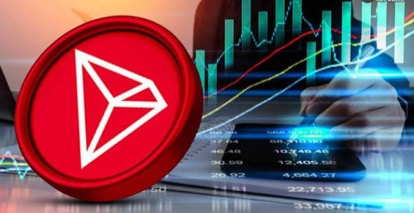 A promotional image featuring the red TRON (TRX) cryptocurrency logo prominently displayed on the left, set against a background of a person using a tablet with financial candlestick charts and numerical data.