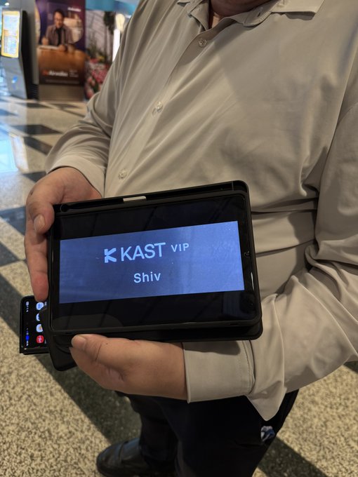 A man holds up a tablet displaying the "KAST VIP" greeting card with the name "Shiv," showcasing the personalized VIP treatment mentioned in the caption upon his arrival in Singapore.