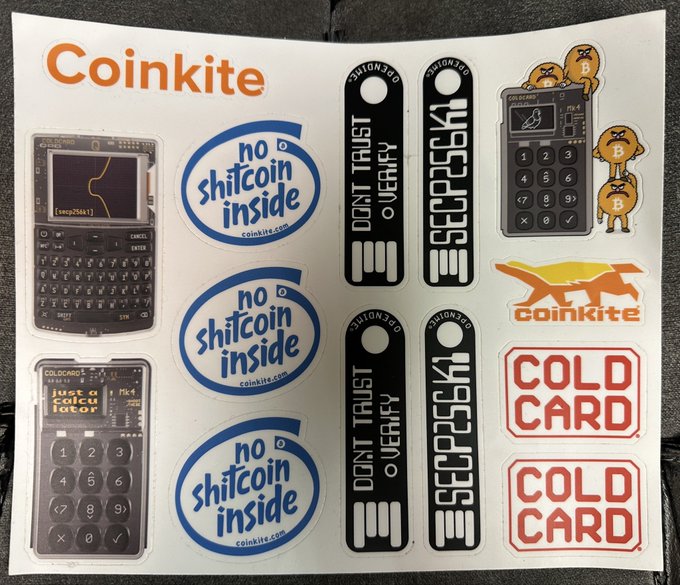 A sticker sheet from Coinkite featuring 'no shitcoin inside' logos, Cold Card stickers, 'DONT TRUST VERIFY' seals, and images of hardware wallets.