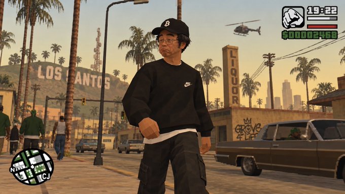 A video game screenshot showing a character wearing a black Nike sweatshirt and 'B' cap standing in Los Santos, with HUD elements displaying 19:22 and $00002468.