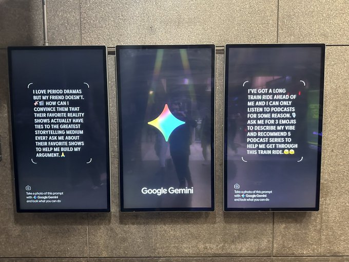 Three digital advertising displays mounted on a stone wall showcase Google Gemini, with the center panel featuring the Gemini logo and the side panels displaying sample user prompts asking for podcast recommendations and arguments about period dramas.