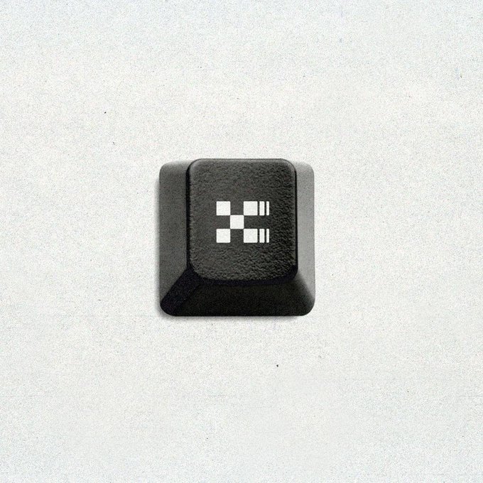The image features a black square keypad with a white "X" symbol at the center of it. The keypad appears to be made of plastic or rubber material, giving it a unique texture. The keypad is placed against a plain white background, which makes its design stand out even more. The post seems to be related to the X Layer, an Exchange OS feature that allows users to share infrastructure across multiple applications. It also mentions "spot, perps, and outcomes in one account per venue," suggesting that this feature can be used by anyone with Exchange Server on their system for various purposes such as testing or development.