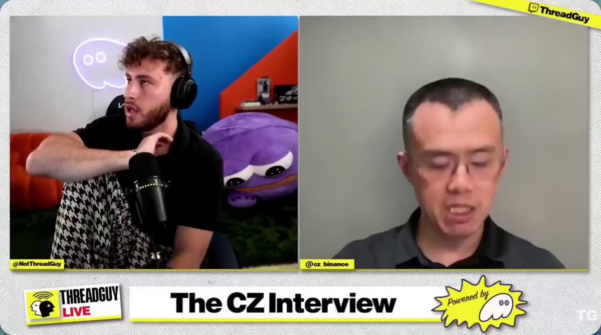 The image shows a man wearing headphones talking into a microphone during an interview. The host of the show has his hand raised, suggesting that he is actively engaged in the conversation or posing for the camera. The background features a gray wall with a yellow border, which provides a neutral backdrop to the scene. The post includes text elements such as "The CZ Interview" and "@Aster_DEX was launched with the belief that it would become the Hyperliquid Killer," indicating that this is an interview about a company or product related to the Hyper Liquid concept.