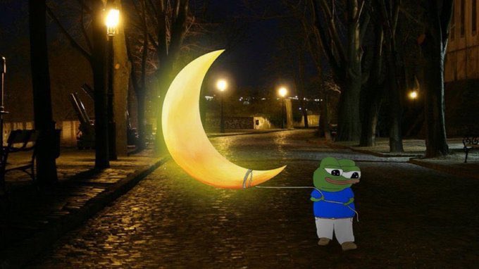 A Pepe the Frog character wearing a blue shirt is walking at night while holding a string attached to a glowing yellow crescent moon on a cobblestone street.