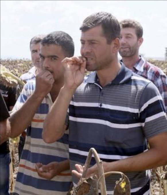 The image shows two men, with the foreground subject bringing his hand to his mouth in a mock-eating gesture, while the post references "Okex Baynyns" with the Turkish phrase "-yiyin birbirinizi" meaning "eat each other," humorously suggesting the men are symbolically "eating" one another as a visual joke about the conflict.