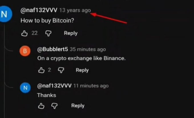 A YouTube comment from user @naf132VVV posted "13 years ago" asks "How to buy Bitcoin?" and receives a reply from @Bubblert5 just "35 minutes ago" suggesting a crypto exchange like Binance, followed by the original user's "Thanks" — humorously showing someone asking the question 13 years late.
