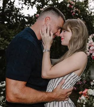 A couple shares an intimate embrace, foreheads touching and smiling at each other, surrounded by blooming pink and white flowers. The romantic, sentimental moment contrasts with the post's speculative comment about tokenizing the relationship's value as a real-world asset (RWA).