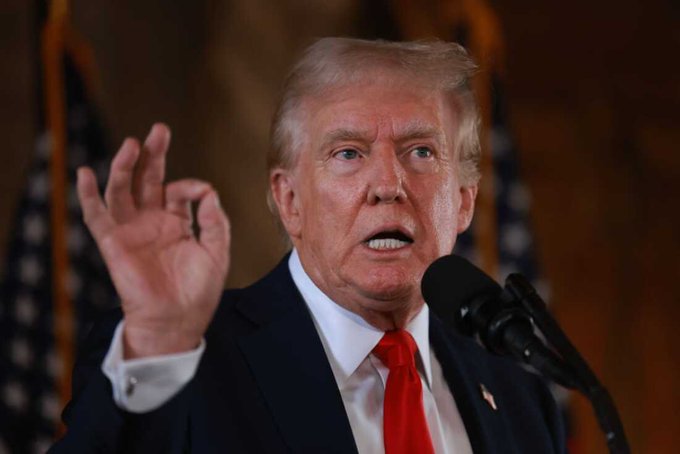 President Donald Trump gestures emphatically while speaking at a podium, advocating for the Senate to pass the Crypto CLARITY Act. This act aims to provide a clear regulatory framework for the cryptocurrency industry in the US.
