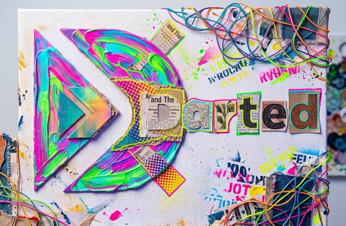 A vibrant, mixed-media art collage featuring colorful painted arrows, scattered text clippings spelling out parts of words like "and The" and "orted", splatters of neon paint, and tangled multicolored wires.