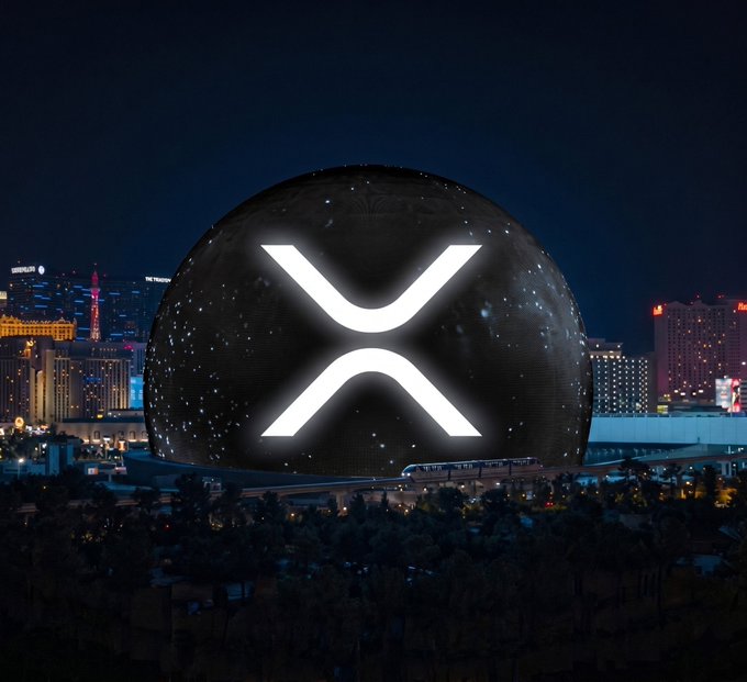 The illuminated Las Vegas Sphere dominates the night skyline, glowing with a starry pattern and displaying the large white XRP logo on its exterior.