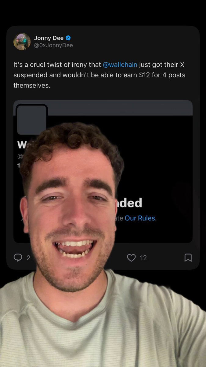 The image features a man with curly hair wearing a white t-shirt, who appears to be smiling at the camera. The caption of the image reads "Wallchain finally got suspended. This shit is too funny. Very deserved actually. Burn you stupid duck." and "Focus on what is in the image and how it relates to the post".
