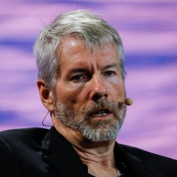 The image shows a man wearing a black suit and sitting at a podium with his mouth open, giving an intense look towards the viewer while speaking about Bitcoin trading strategies. He appears to be explaining why he lost more than he gained from a recent transaction of exchanging Bitcoins for Etherium (ETH). The setting seems to be an event where he is delivering a speech or presentation, possibly related to cryptocurrency or investing in digital assets like Bitcoin.