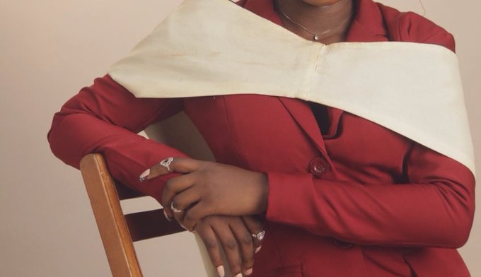 The image shows a person in a red suit with a white sash sitting on a wooden chair, visually representing the 'BSc in Biochemistry secured' mentioned in the text, while the caption indicates they now 'cook both offchain and onchain'.