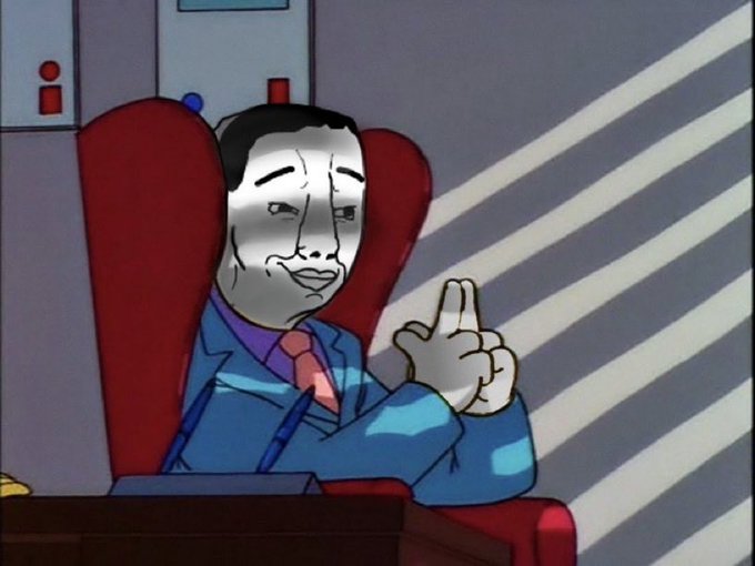 A cartoon figure in a blue suit with a purple tie and red/orange nose sits in a high-backed red chair, making a "V" or "I'm watching you" gesture with two fingers pointed upward. The hand gesture visually echoes the "I'm holding it" caption, as the raised fingers appear to be gripping or presenting an unseen object.