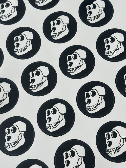 A black and white skull design arranged in a repeating pattern of circular logos, each featuring a stylized skull within a black ring, aligning with the post's reference to the Bored Ape Yacht Club's skull motif.