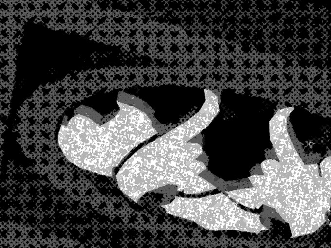A black and white abstract or glitch-style image featuring a swirling ribbon-like form with a heavily textured, speckled background.