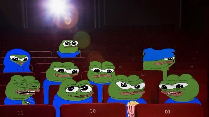 Multiple Pepe the Frog characters wearing blue hoodies sitting in a dark movie theater with seat numbers visible and a box of popcorn in the foreground.