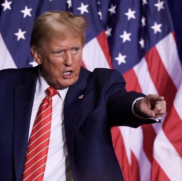 Donald Trump points his finger aggressively while speaking in front of a row of American flags, his expression intense as he addresses an audience. The image is paired with promotional text announcing a "$1 listing" presale for a token called "Binance" associated with Trump, suggesting the photo is being used to lend credibility or relevance to the misleading cryptocurrency advertisement.