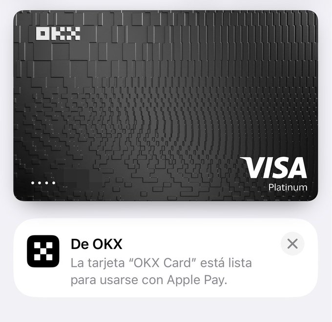 A black OKX Visa Platinum card is displayed with an Apple Pay notification from OKX confirming in Spanish that the "OKX Card" is ready to use with Apple Pay. The image visually supports the thread's tutorial on adding the OKX card to Apple Pay from Venezuela for App Store purchases and contactless payments.