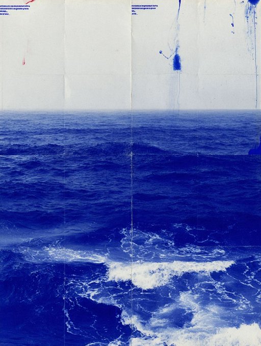 A vast, deep blue ocean stretches toward a hazy horizon beneath a pale sky, with the choppy water in the foreground transitioning to calmer waves in the distance. The image is treated as a digital artwork titled "folded horizons #11" by gm, with blue paint drips and streaks at the top edge blurring the line between sea and sky, available on SuperRare.