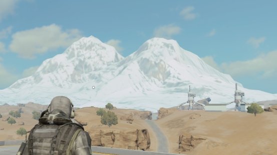 A video game screenshot showing a character in tactical gear overlooking a snowy mountain landscape with buildings and radio towers in the distance.