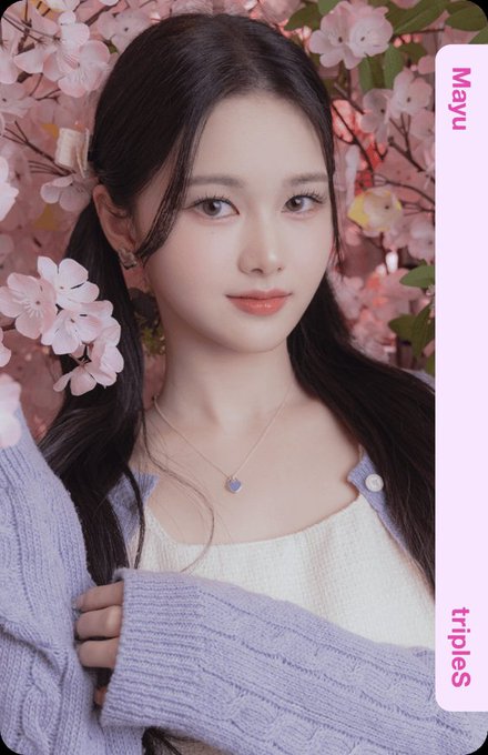 A photo card features a young woman identified as 'Mayu' from the group 'tripleS,' posing with pink cherry blossoms and wearing a delicate heart pendant necklace.
