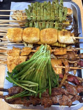The image features a tray filled with various types of food, including meat, vegetables, and other items such as corn and broccoli. The food appears to be cooked or prepared for consumption. The post includes information about Bitcoin wallets and cryptocurrency, which is unrelated to the food displayed in the image.