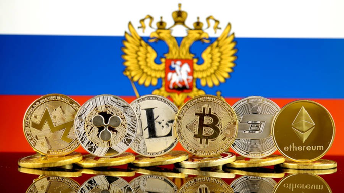A row of cryptocurrency coins, including Monero, Litecoin, Bitcoin, and Ethereum (labeled "ethereum"), stands against the Russian flag featuring the national double-headed eagle emblem. The image visually reinforces Russia's recent move to officially recognize select cryptocurrencies like Bitcoin, Ethereum, and USDT for public trading starting September 1.