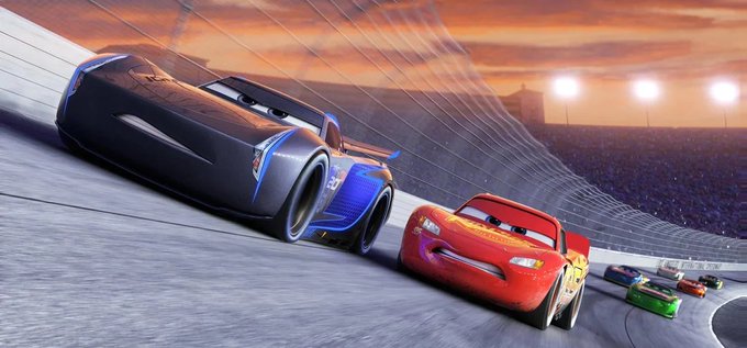 Lightning McQueen races alongside Jackson Storm on a track at sunset, mirroring the post's theme of Monad overtaking AVAX (a rival blockchain) in a competitive "race" for TVL dominance. The image is a classic Pixar promotional still from *Cars 3*, symbolizing a fast contender passing an established leader.