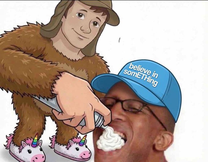 A meme image featuring a cartoon caveman with unicorn slippers spraying whipped cream into the mouth of a man wearing a blue cap labeled 'believe in somETHing'.
