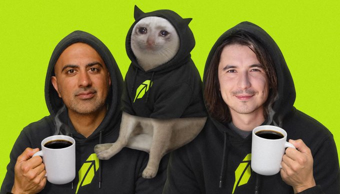 Two men in hoodies and a cat in a hoodie pose holding coffee mugs against a bright green background, with all hoodies featuring a yellow leaf logo, playing on the "hood morning" caption as a pun.