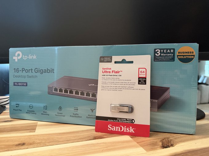 New hardware for $MADE's setup—a TP-LINK TL-SG116 16-Port Gigabit Desktop Switch and a SanDisk Ultra Flair 64GB USB 3.0 drive—proudly displayed as selfmade (@) begins assembling the infrastructure for his business.