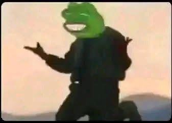 A low-quality video still of a person wearing a green Kermit the Frog mask and black outfit, appearing to be in an expressive pose against a blurred background.