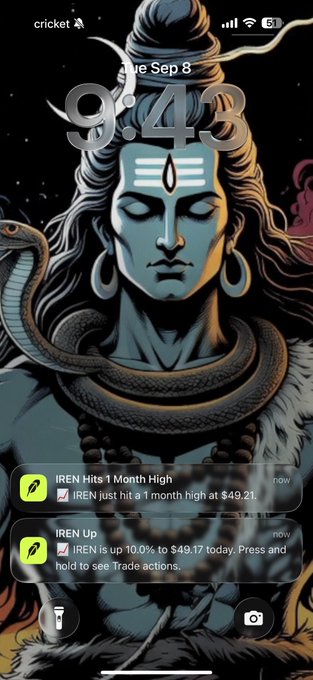 A lock screen at 9:43 AM on Tue, Sep 8, features a striking digital illustration of Lord Shiva with a cobra around his neck against a starry background, alongside two stock notifications showing IREN hitting a 1-month high at $49.21 and being up 10.0% to $49.17—tying in with the post about IREN's significant surge.