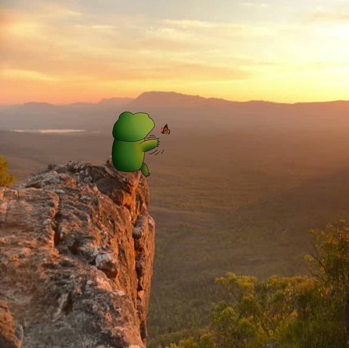 A cute green cartoon frog sits on the edge of a rocky cliff at sunset, reaching out toward a small butterfly. The serene landscape and contemplative mood of the image complement the post's encouraging message about staying focused on convictions and making the day count.