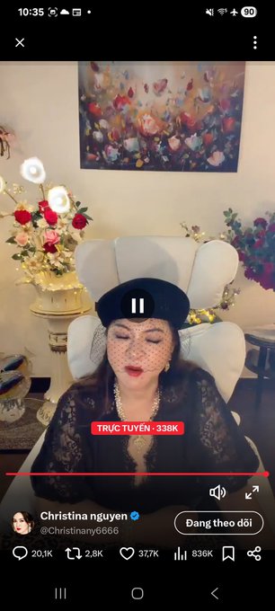 A mobile screenshot of an X/Twitter video shows a woman wearing a black hat with a veil and lace outfit in an ornate room, posted by user "Christina nguyen @Christinany6666" with 20.1K reposts, 2.8K comments, 37.7K likes, and 336K views, labeled "TRỰC TUYẾN · 338K" viewers.