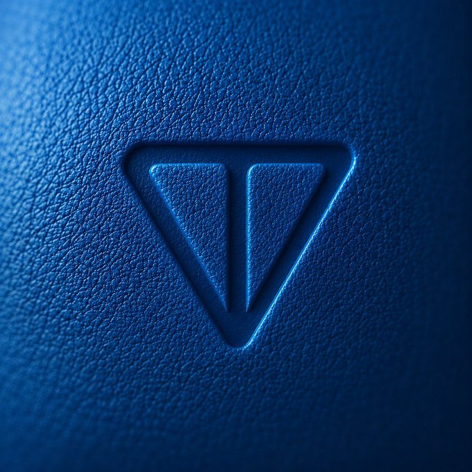 The image features a striking blue object with a triangle shape, giving it an abstract design. The background of the image is also blue, which complements the color scheme. There are two thumbs up symbols placed near the bottom right corner and above the top left corner, possibly indicating approval or agreement.